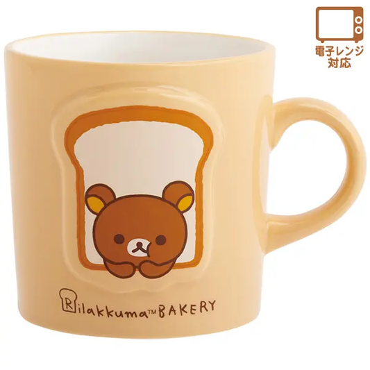 Rilakkuma Bakery mug in cream with Rilakkuma peeking through a toast design and a rounded handle.