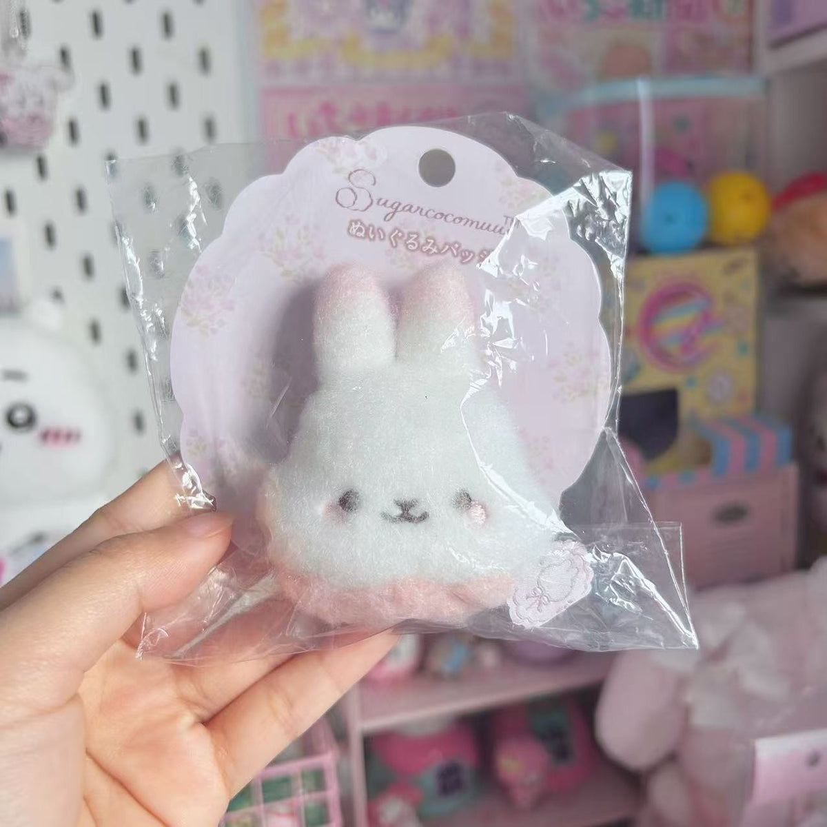 Sugarcocomuu white bunny face plush brooch badge with pink ears in its packaging