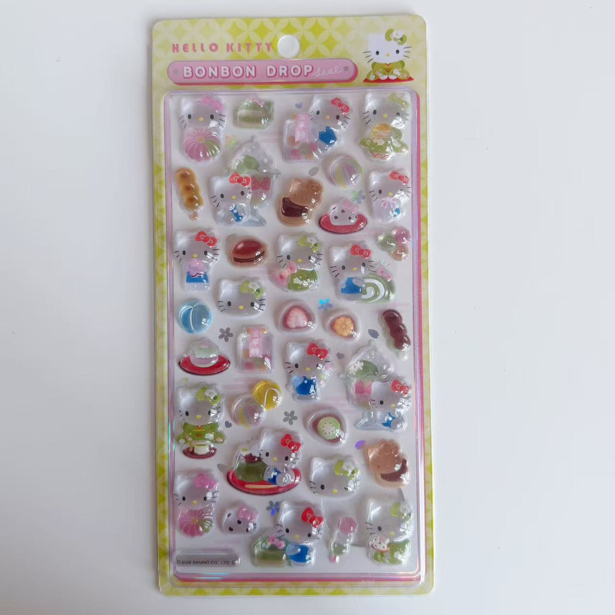 Hello Kitty BONBON DROP Japanese Sweets 3D sticker sheet with green packaging, dango and matcha-themed treats.