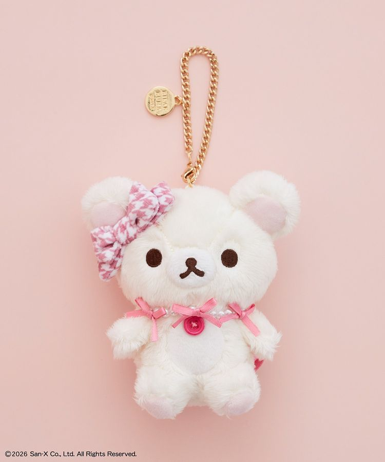 Korilakkuma x Maison de FLEUR plush bag charm with a pink houndstooth head bow, pink ribbon details, red button and gold-coloured chain.