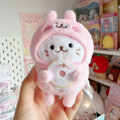 Sirotan white seal plush mascot wearing a pink Kanahei rabbit costume and holding a donut with a Piske face.