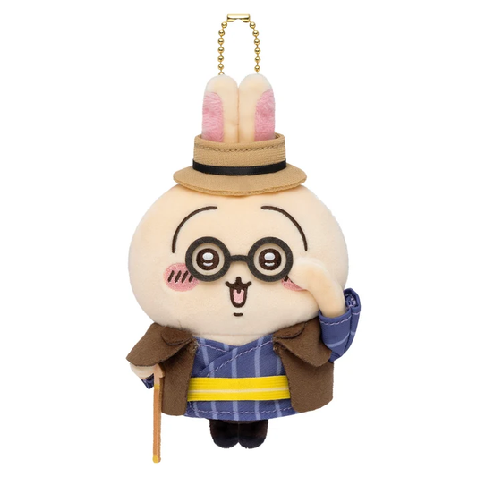 Chiikawa Usagi Otaru Retro plush bag charm with round glasses, a straw-style hat, brown cape, blue outfit and gold-coloured ball chain.